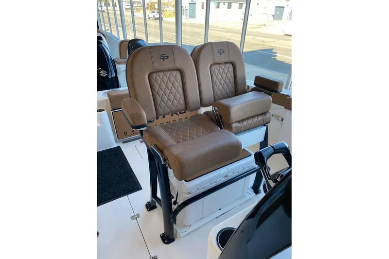 Slide: The Image of 2024 Sea Pro 259 DLX boat seats with brown leather and diamond stitching design. - 3