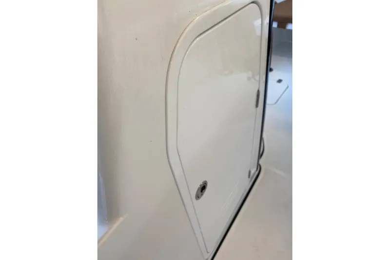 Slide: The Image of 2024 Sea Pro 259 DLX boat compartment door, white finish. - 8