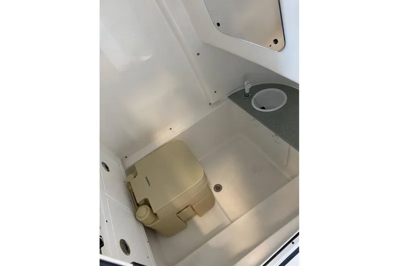Slide: The Image of 2024 Sea Pro 259 DLX boat interior with compact toilet and sink. - 9