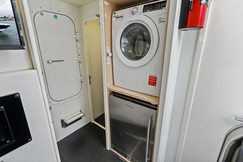 Slide: The Image of Laundry area with washer and dryer on a 2012 Sunseeker 88 Yacht. - 103