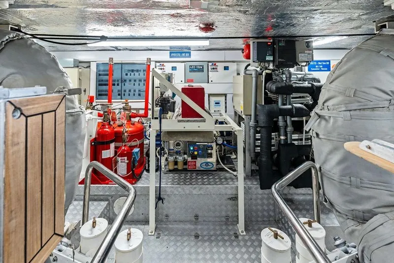 Slide: The Image of Engine room of a 2012 Sunseeker 88 Yacht, featuring machinery and safety equipment. - 106