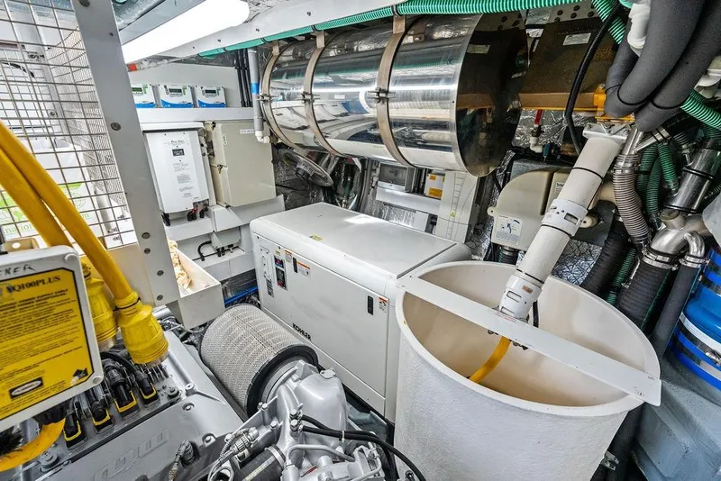 Slide: The Image of Engine room of a 2012 Sunseeker 88 Yacht, featuring mechanical equipment and wiring. - 111