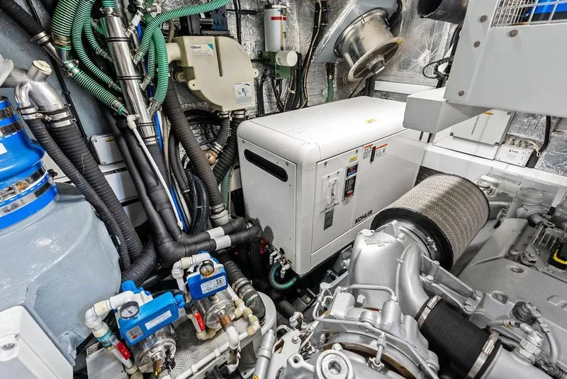 Slide: The Image of Engine room of a 2012 Sunseeker 88 Yacht, featuring Kohler generator and complex piping system. - 112