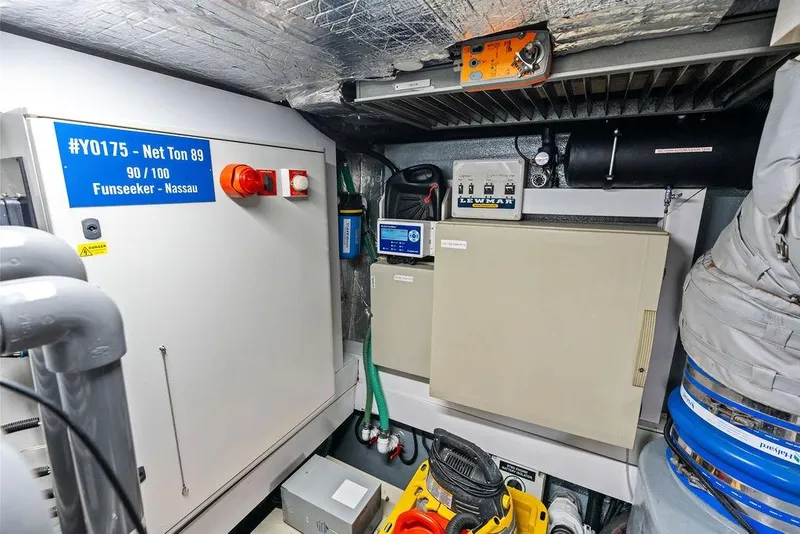 Slide: The Image of Engine room of a 2012 Sunseeker 88 Yacht, featuring control panels and equipment. - 113