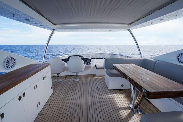 Slide: The Image of Luxurious 2012 Sunseeker 88 Yacht deck with ocean view, featuring elegant seating and wooden table. - 12