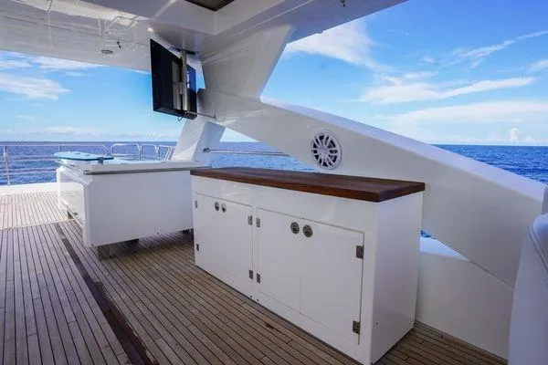 Slide: The Image of Sunseeker 88 Yacht 2012 deck with ocean view, featuring cabinetry and outdoor TV. - 13