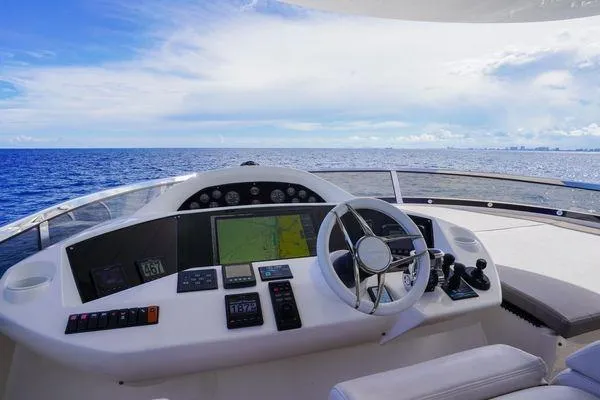 Slide: The Image of Helm of 2012 Sunseeker 88 Yacht with ocean view and navigation equipment. - 17
