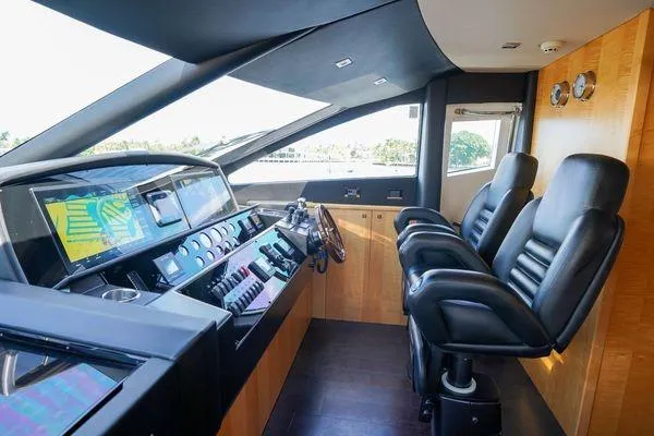 Slide: The Image of Luxurious helm of 2012 Sunseeker 88 Yacht with modern navigation controls and leather seating. - 24