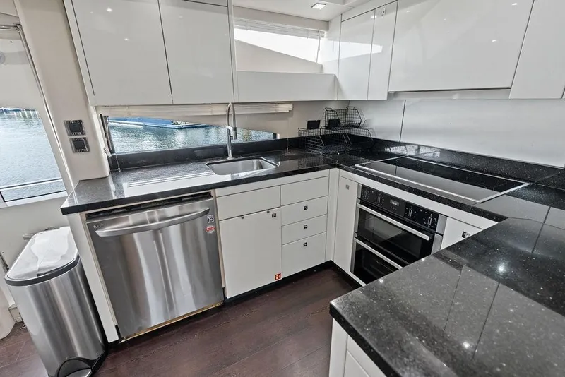 Slide: The Image of Modern kitchen interior on 2012 Sunseeker 88 Yacht with sleek appliances and black countertops. - 59