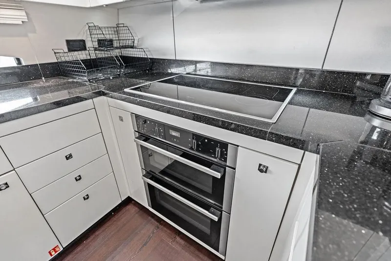 Slide: The Image of Modern kitchen in 2012 Sunseeker 88 Yacht with sleek black countertops. - 62