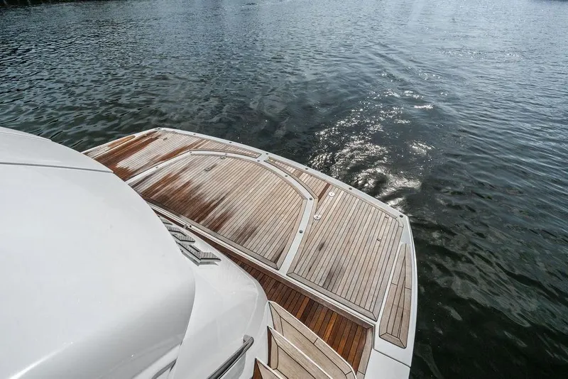 Slide: The Image of Sunseeker 88 Yacht 2012, elegant wooden deck, gliding on serene water. - 64