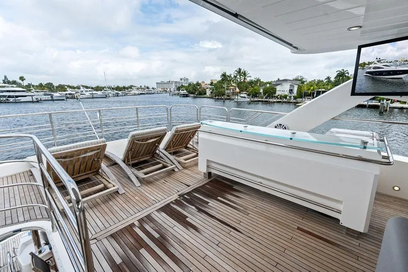 Slide: The Image of Luxurious Sunseeker 88 Yacht 2012 deck with sun loungers and scenic waterfront view. - 73