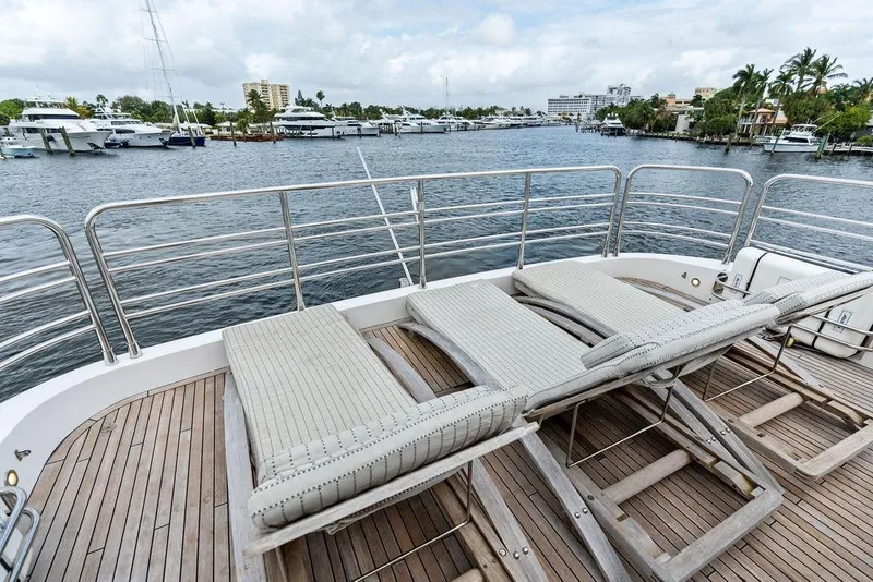 Slide: The Image of Sunseeker 88 Yacht 2012 deck with lounge chairs overlooking marina. - 74