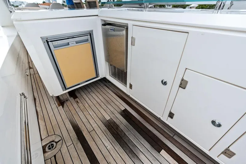 Slide: The Image of Sunseeker 88 Yacht 2012 deck with storage compartments and wooden flooring. - 75