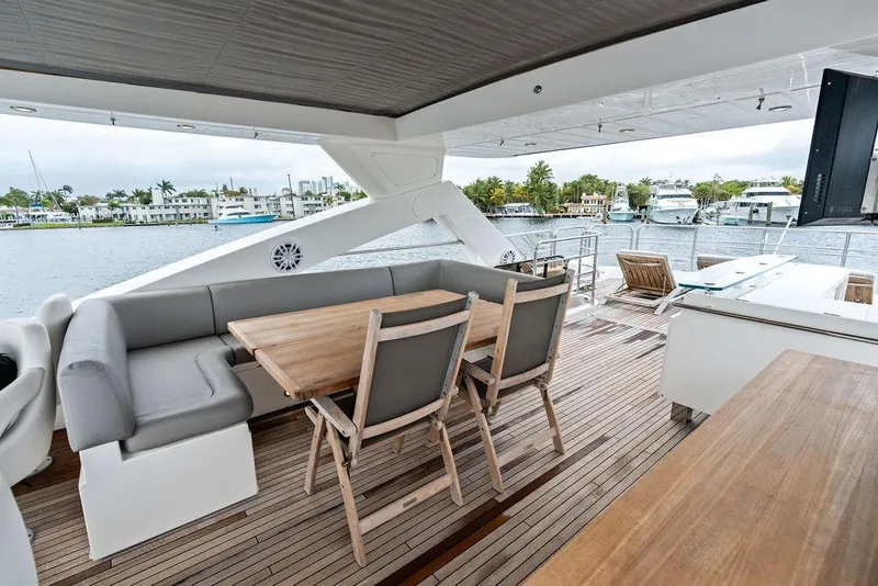 Slide: The Image of Luxurious Sunseeker 88 Yacht 2012 with elegant outdoor seating and scenic waterfront view. - 76