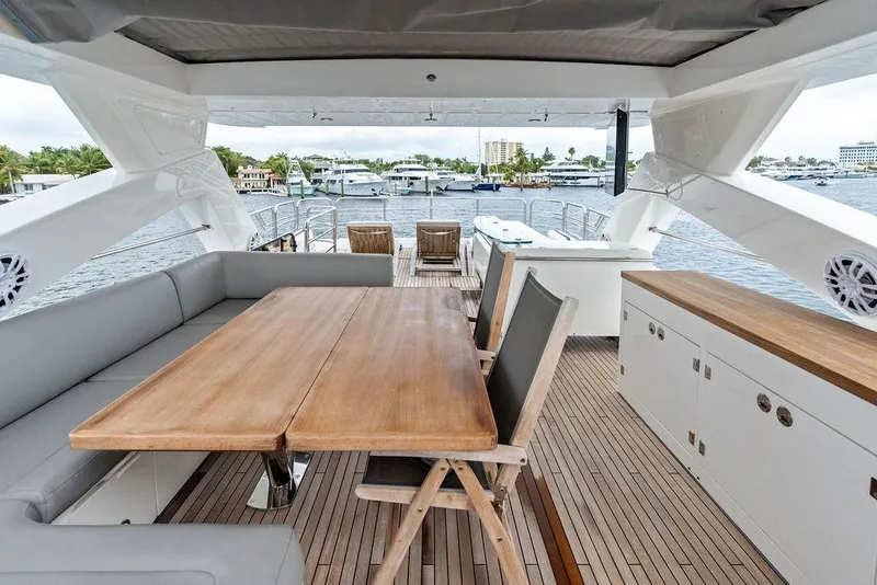 Slide: The Image of Luxurious 2012 Sunseeker 88 Yacht deck with elegant seating and scenic marina view. - 77