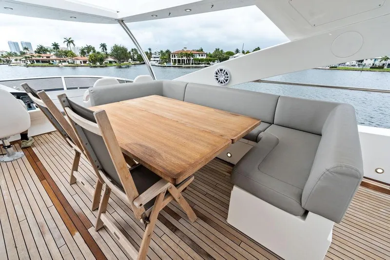 Slide: The Image of Luxurious Sunseeker 88 Yacht 2012 deck with wooden table and cushioned seating. - 80