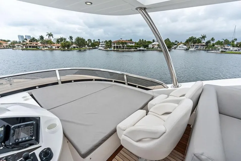 Slide: The Image of Luxurious 2012 Sunseeker 88 Yacht deck with seating, overlooking serene waterfront homes. - 81