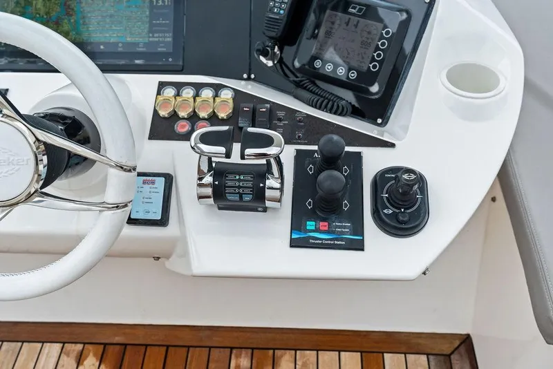 Slide: The Image of Sunseeker 88 Yacht 2012 helm controls with steering wheel and navigation instruments. - 84