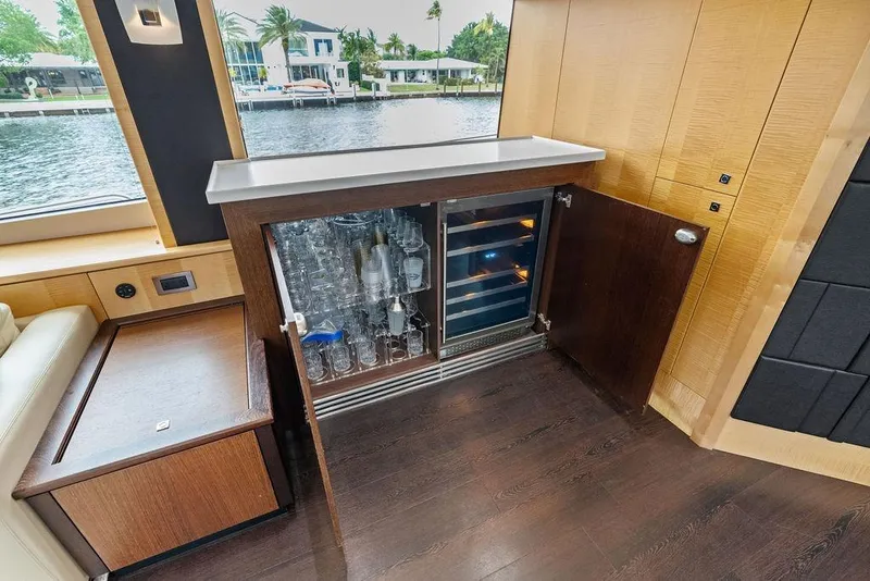 Slide: The Image of Luxurious Sunseeker 88 Yacht interior with glassware cabinet and scenic water view, 2012 model. - 94