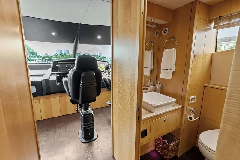 Slide: The Image of Luxurious interior of 2012 Sunseeker 88 Yacht featuring helm and bathroom area. - 97