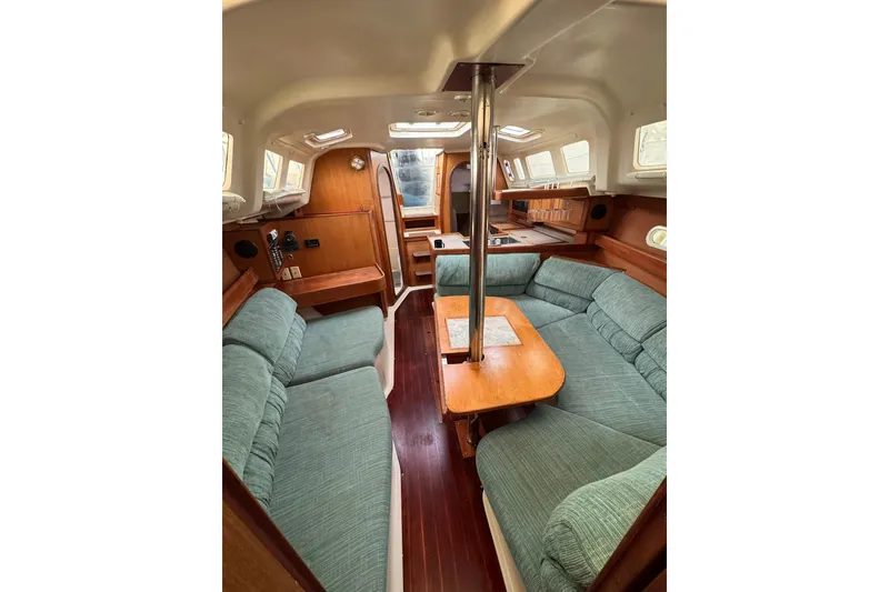 Slide: The Image of Interior of a 1997 Hunter 340 sailboat with cozy seating and wooden finishes. - 11