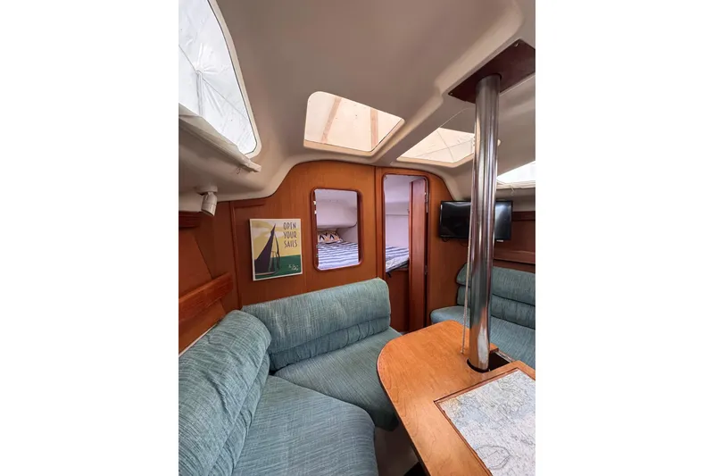 Slide: The Image of Interior of a 1997 Hunter 340 sailboat with cozy seating and nautical decor. - 5