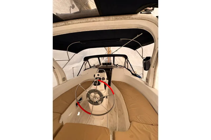 Slide: The Image of Interior view of a 1997 Hunter 340 sailboat cockpit with steering wheel and seating. - 9