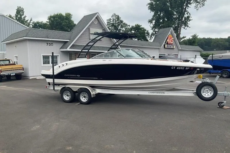 The Image of 2023 Chaparral 23 SSi boat on trailer outside dealership. - 1