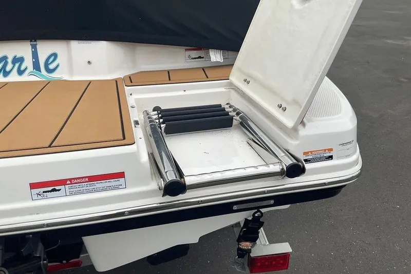 Slide: The Image of 2023 Chaparral 23 SSi boat with open swim platform ladder and safety warnings. - 12