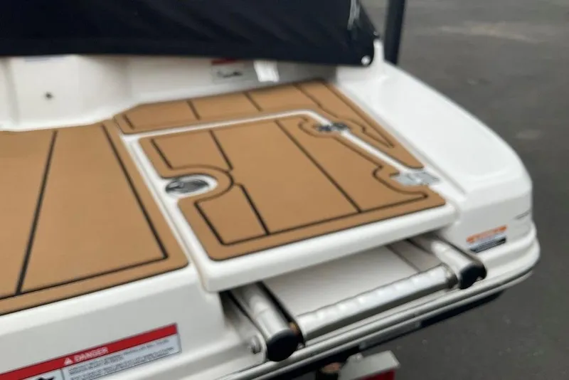 Slide: The Image of 2023 Chaparral 23 SSi boat swim platform with teak-style decking and retractable ladder. - 13