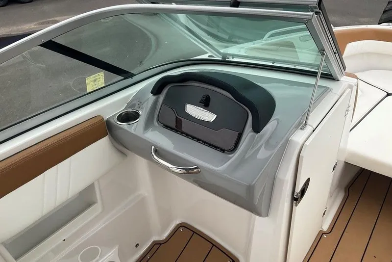 Slide: The Image of 2023 Chaparral 23 SSi boat interior with sleek dashboard and seating area. - 20