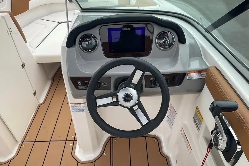 Slide: The Image of 2023 Chaparral 23 SSi boat dashboard with steering wheel and control panel. - 22