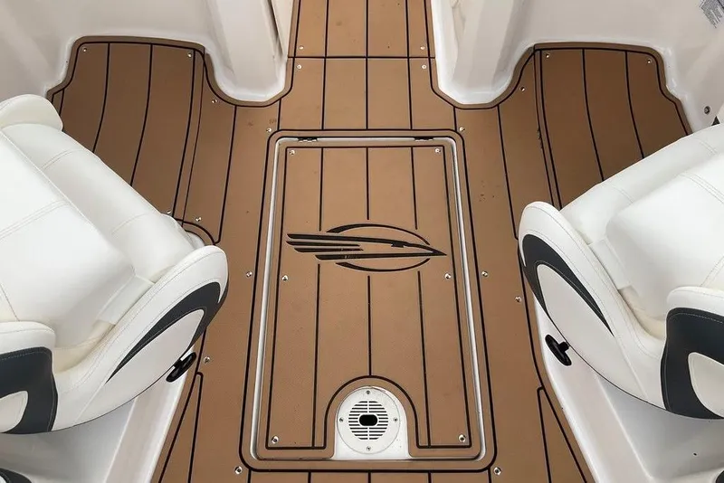 Slide: The Image of 2023 Chaparral 23 SSi boat interior with teak-style flooring and white seating. - 26