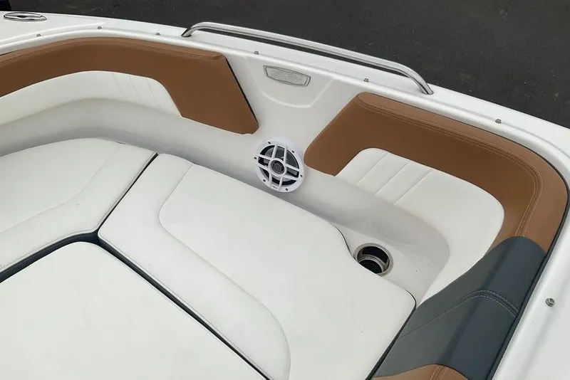 Slide: The Image of 2023 Chaparral 23 SSi boat interior with white and brown seating. - 27