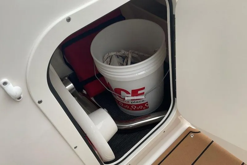 Slide: The Image of Storage compartment in 2023 Chaparral 23 SSi boat with bucket and equipment. - 33