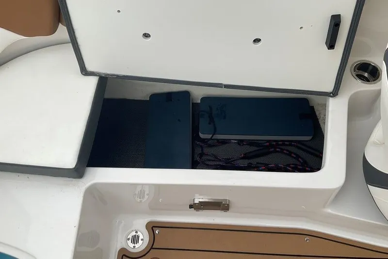 Slide: The Image of Open storage compartment on 2023 Chaparral 23 SSi boat, showing interior details. - 35