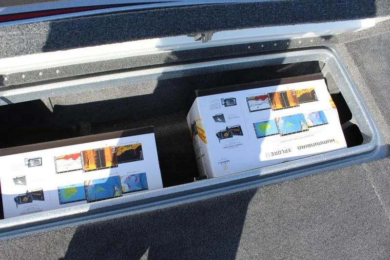 Slide: The Image of Storage compartment in a 2026 Phoenix 921 Elite X boat with electronic equipment boxes. - 11