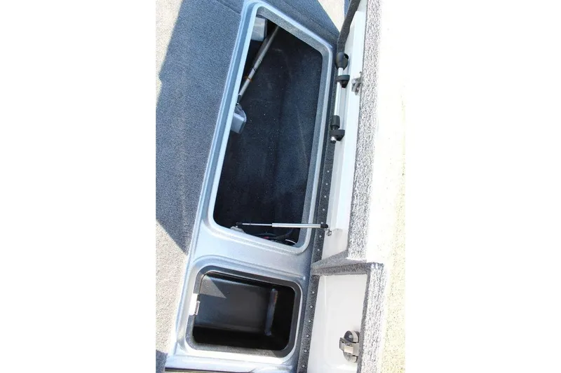 Slide: The Image of Open storage compartment in 2026 Phoenix 921 Elite X boat. - 12