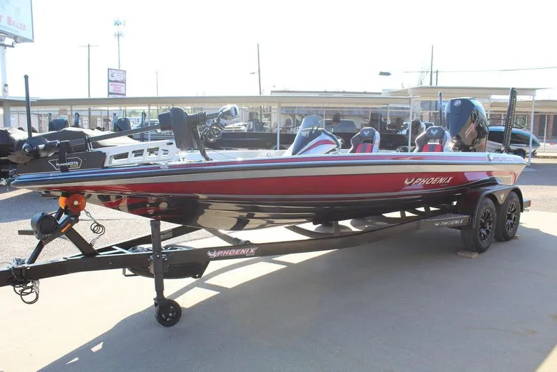 Slide: The Image of 2026 Phoenix 921 Elite X boat on trailer, red and black design, parked outdoors. - 13