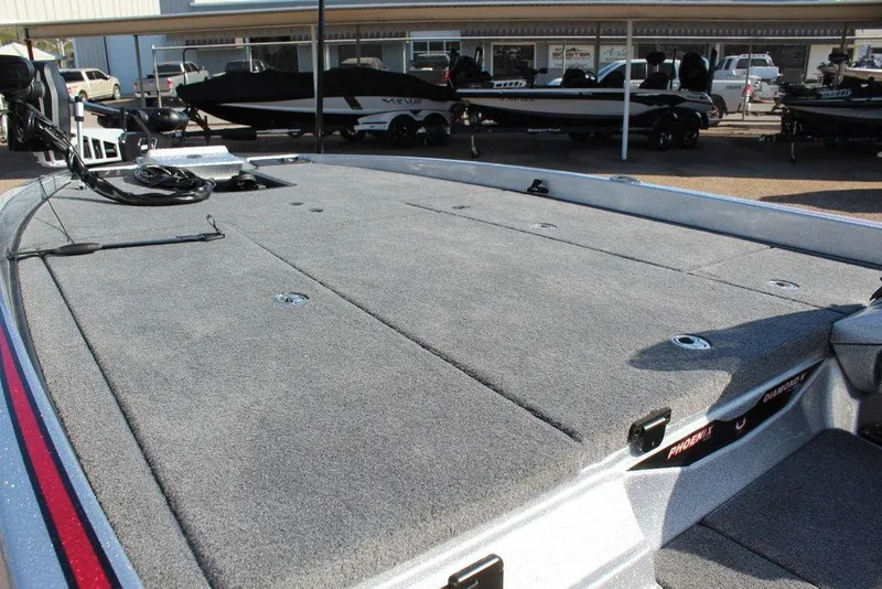 Slide: The Image of 2026 Phoenix 921 Elite X boat deck with carpeted surface and storage compartments. - 14
