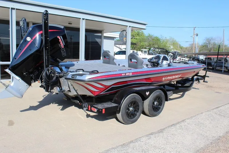 Slide: The Image of 2026 Phoenix 921 Elite X boat with dual axle trailer, parked outdoors. - 4