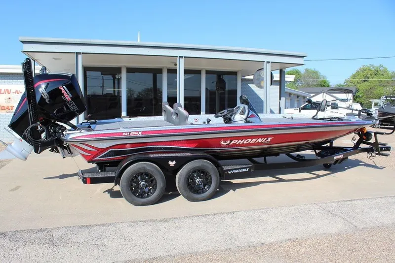 Slide: The Image of 2026 Phoenix 921 Elite X boat on trailer, parked outside a building. - 7