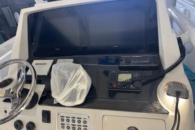 Slide: The Image of Control panel of a 2015 Intrepid 327 Center Console boat with navigation equipment. - 2