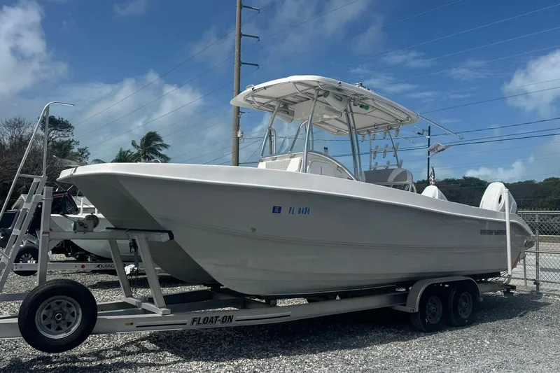 The Image of 2019 Twin Vee 26 Center Console boat on trailer under clear blue sky. - 0
