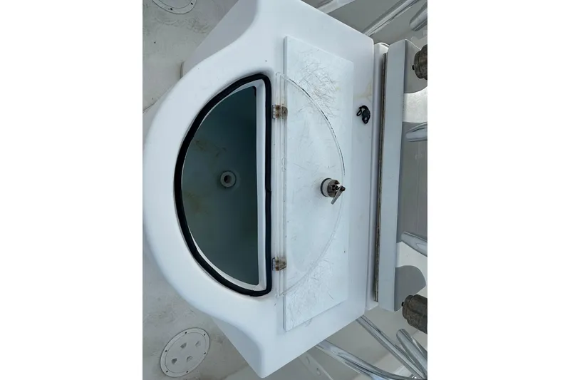 Slide: The Image of 2019 Twin Vee 26 Center Console livewell with open lid, showing interior details. - 10