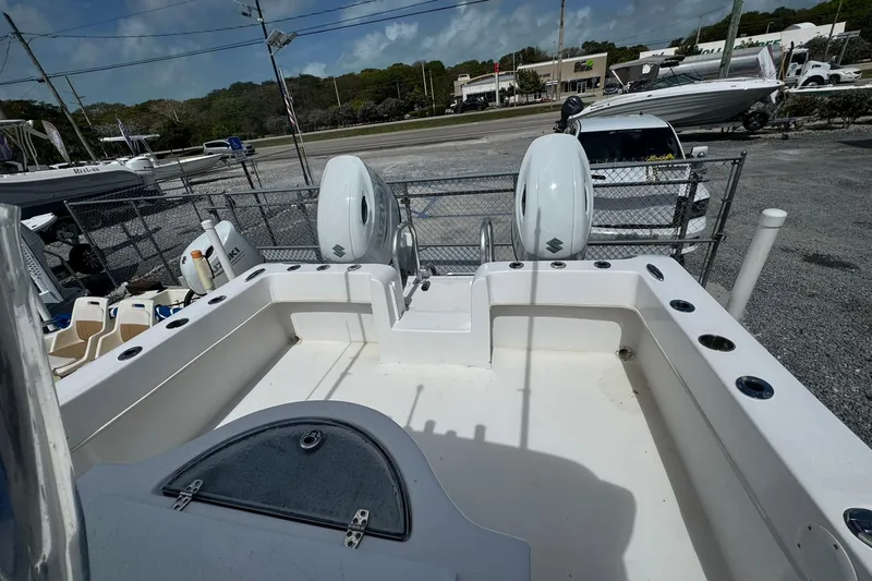 Slide: The Image of 2019 Twin Vee 26 Center Console boat with dual outboard engines, parked outdoors. - 11