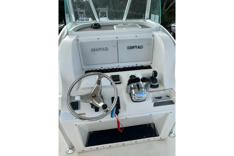 Slide: The Image of 2019 Twin Vee 26 Center Console helm with Simrad electronics and steering wheel. - 3
