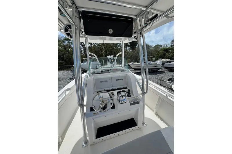 Slide: The Image of 2019 Twin Vee 26 Center Console boat interior with steering wheel and controls. - 4