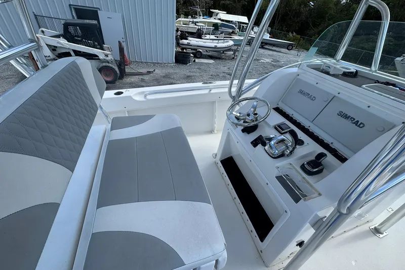 Slide: The Image of 2019 Twin Vee 26 Center Console boat interior with steering wheel and Simrad electronics. - 5